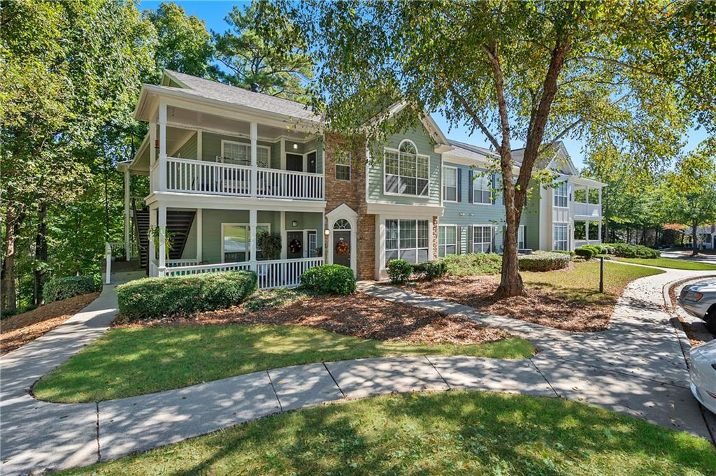 10055 Jones Bridge Road, Unit 206 Johns Creek, GA 30022 - Photo 13 of 28 a view of a house with a yard and large tree