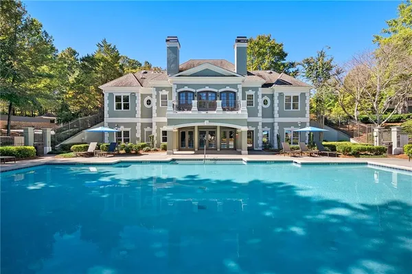 a front view of a house with swimming pool having outdoor seating