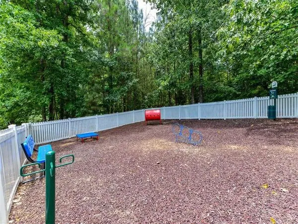 a view of a backyard with wooden fence