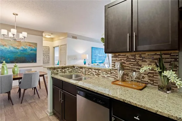 a kitchen with a sink and a stove top oven