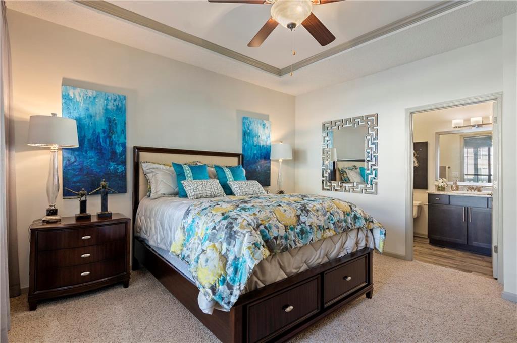 10055 Jones Bridge Road, Unit 206 Johns Creek, GA 30022 - Photo 6 of 28 a bedroom with a bed and a chandelier