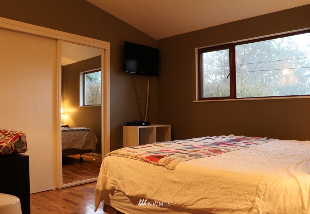 24015 4th Place West Bothell, WA 98021 - Photo 7 of 14 a bedroom with a bed and wooden floor