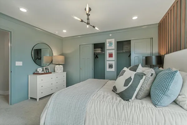 a bedroom with a bed and a dresser