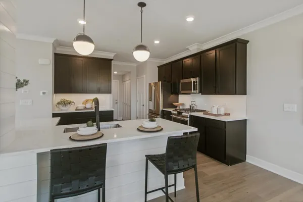 a kitchen with sink stove and microwave