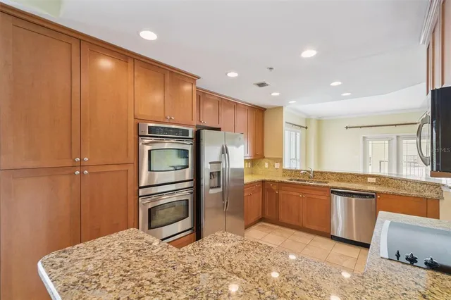 a view of a living room with wooden floor and a kitchen