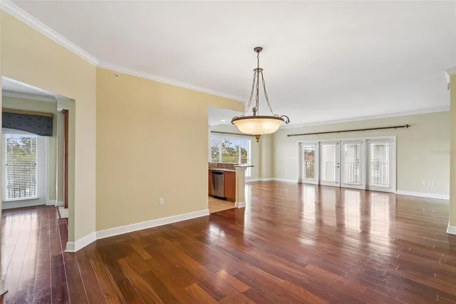 a view of a kitchen with cabinets and wooden floor
