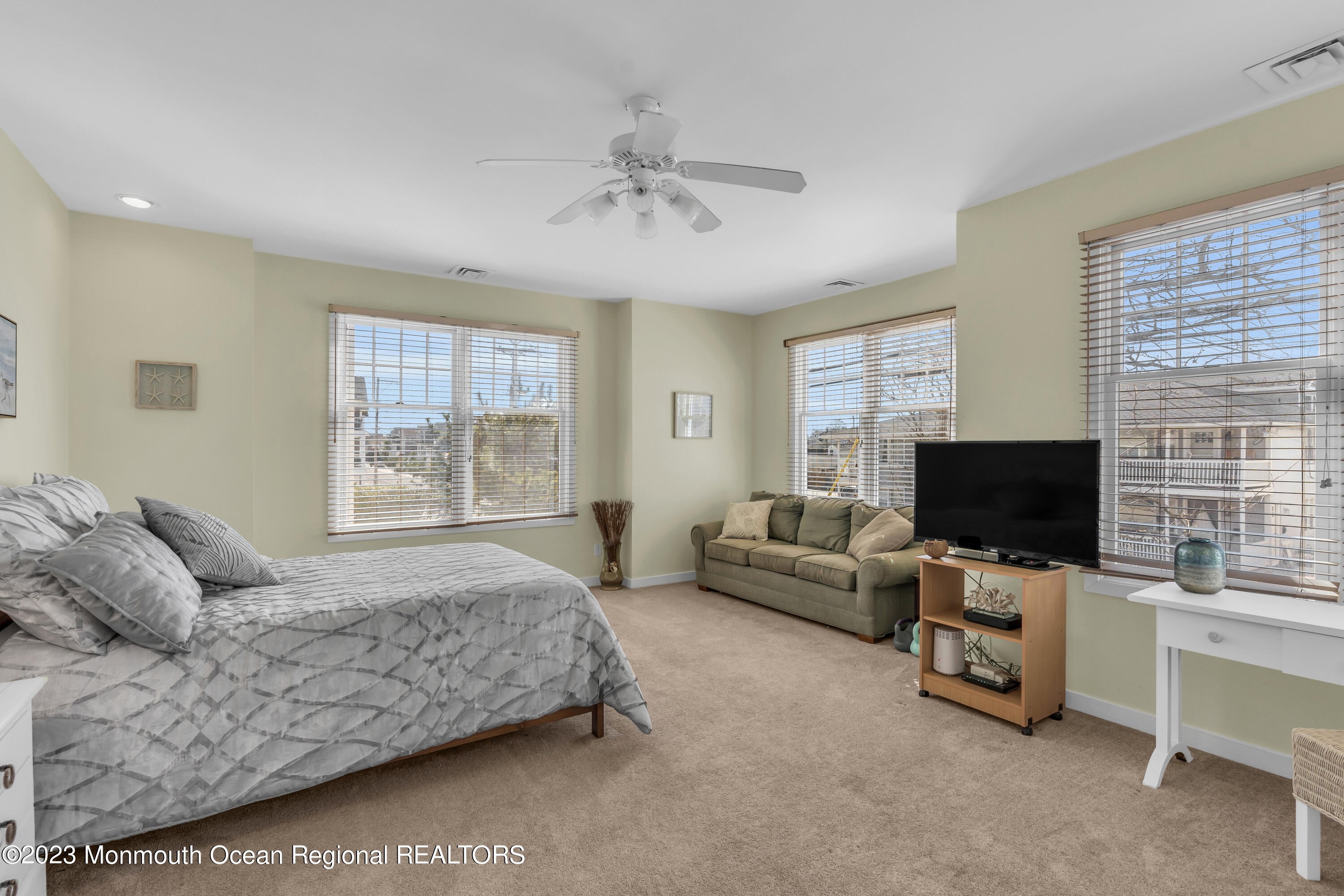 239 Beach Front, Unit 1 Manasquan, NJ 08736 - Photo 15 of 31 a spacious bedroom with a bed and a flat screen tv