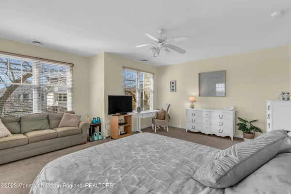 a bedroom with furniture and a flat screen tv