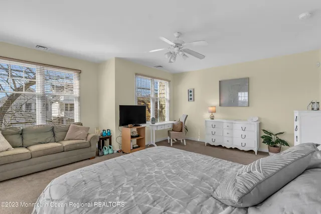 a bedroom with furniture and a flat screen tv
