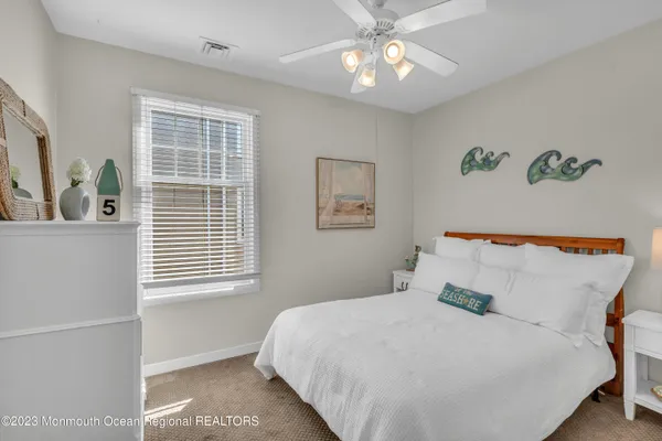 a bedroom with a large bed and a window