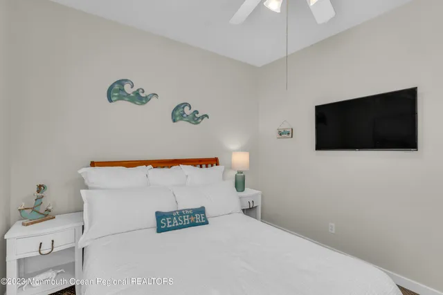 a bathroom with a bathtub and a flat screen tv