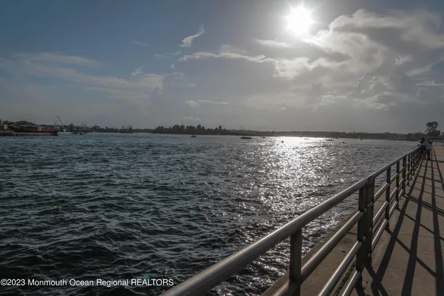 a view of roof deck with wooden floor and fence