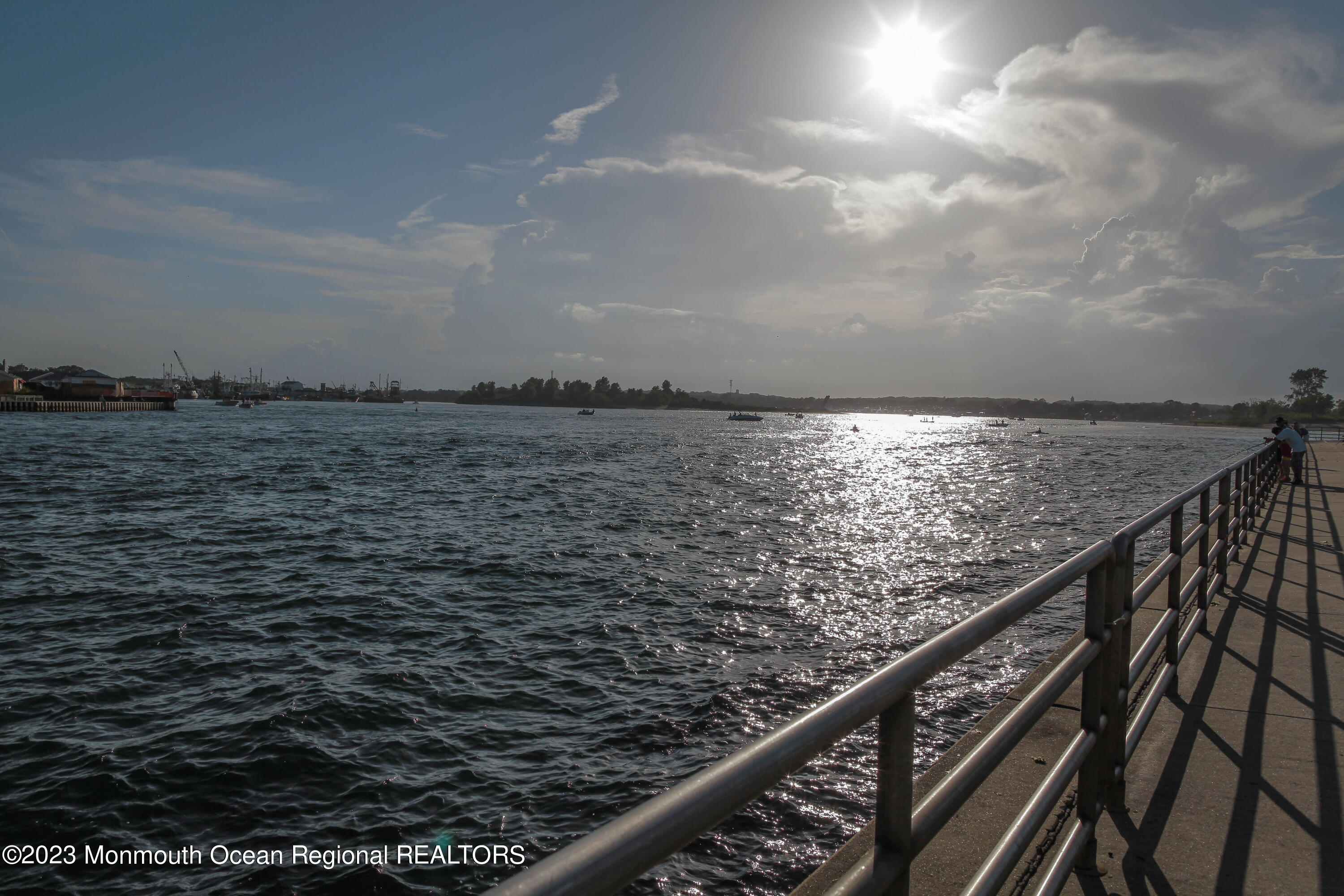 239 Beach Front, Unit 1 Manasquan, NJ 08736 - Photo 28 of 31 a view of roof deck with wooden floor and fence