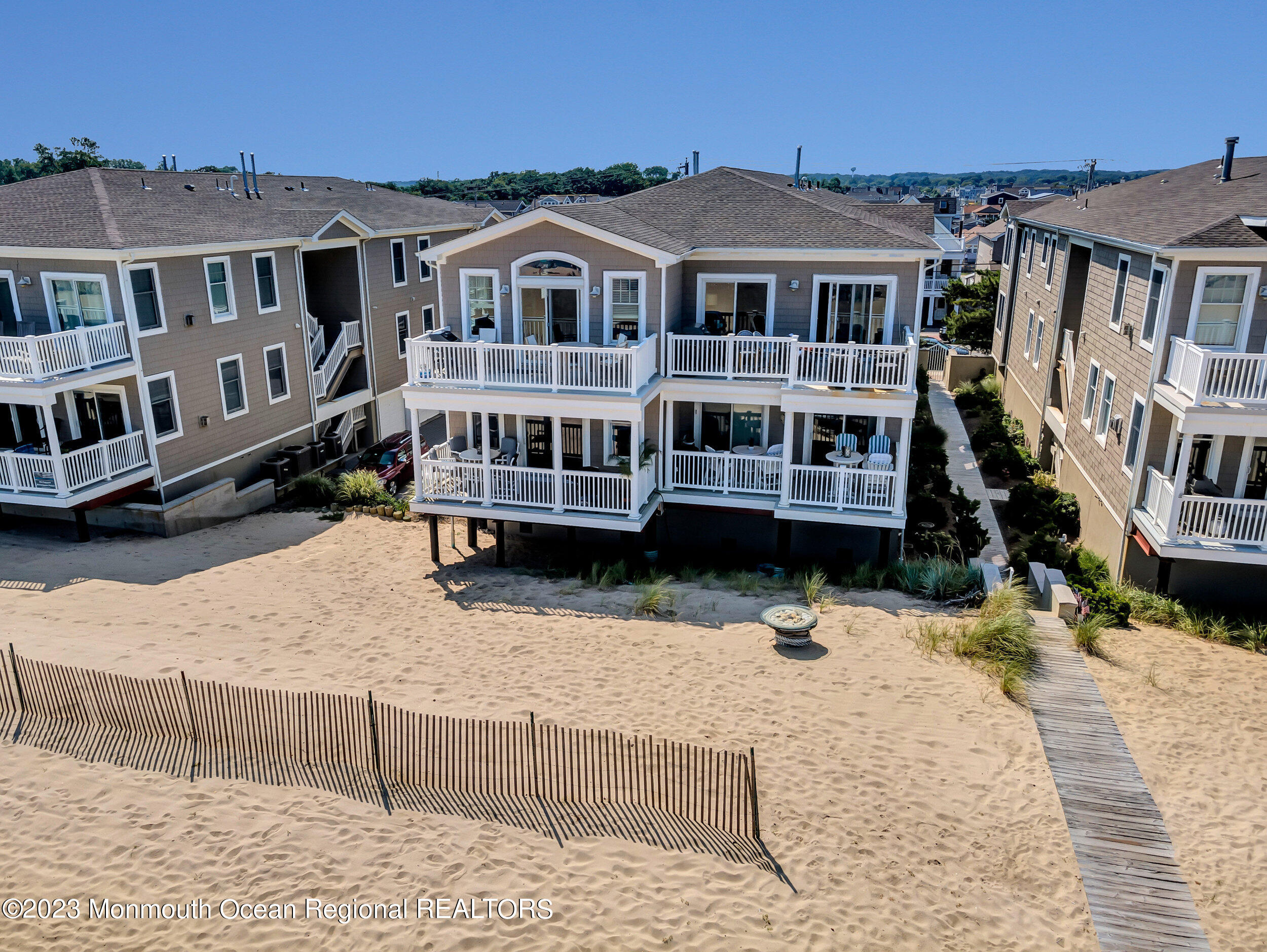 239 Beach Front, Unit 1 Manasquan, NJ 08736 - Photo 4 of 31 a front view of a building with large windows