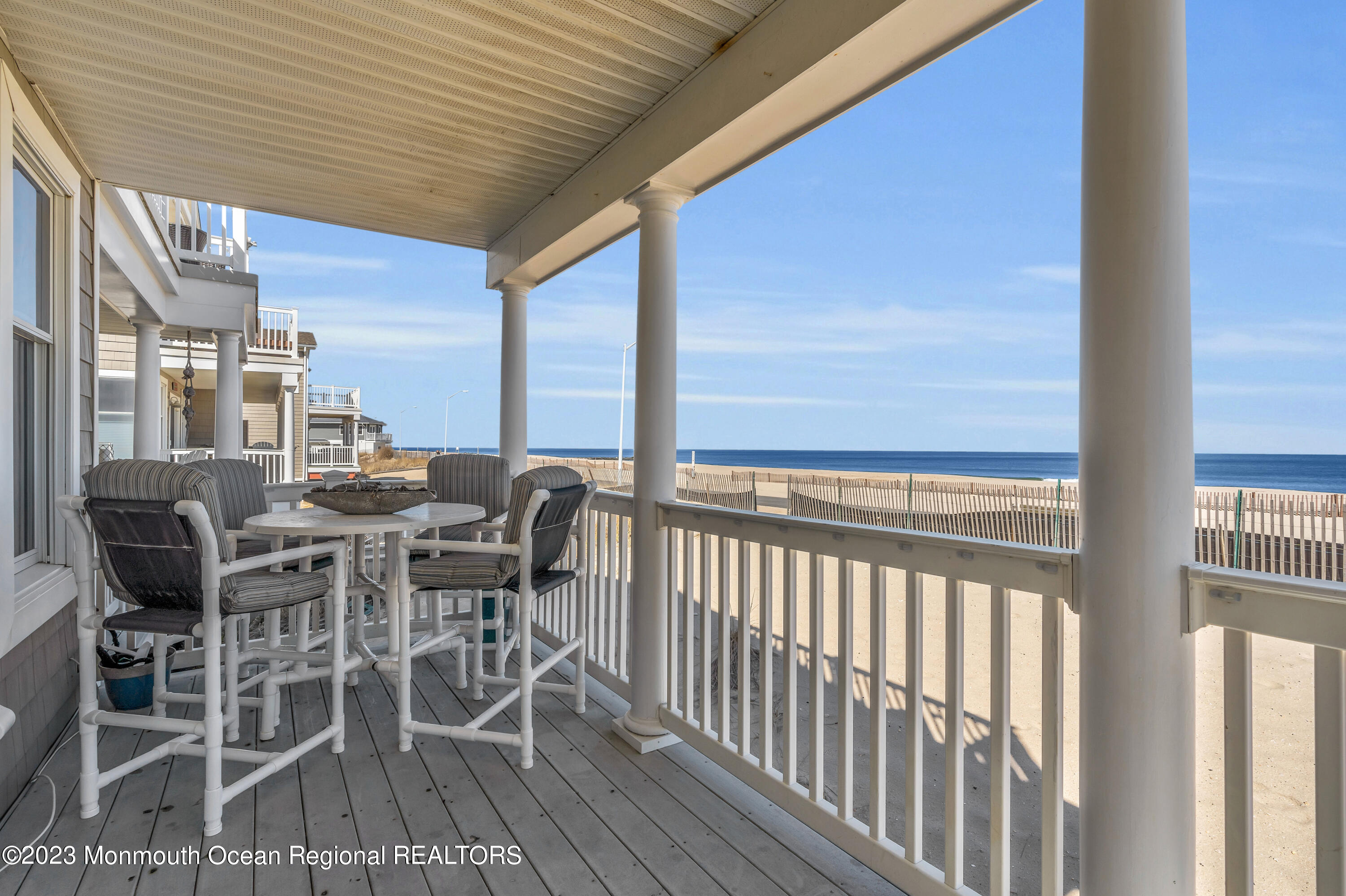 239 Beach Front, Unit 1 Manasquan, NJ 08736 - Photo 5 of 31 a view of a patio with table and chairs and floor to ceiling window