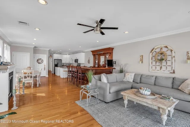 a living room with furniture and a view of kitchen