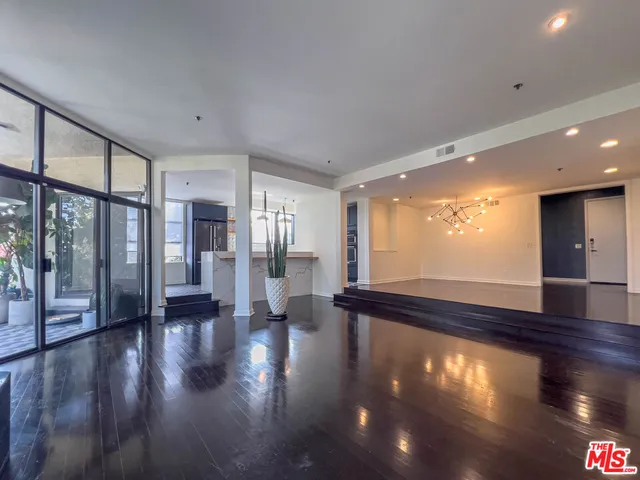 a kitchen with stainless steel appliances a stove a sink and a large window