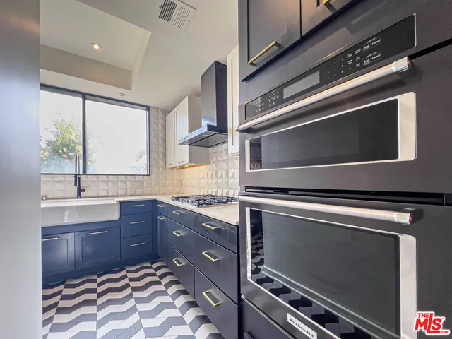 a kitchen with a sink and a stove