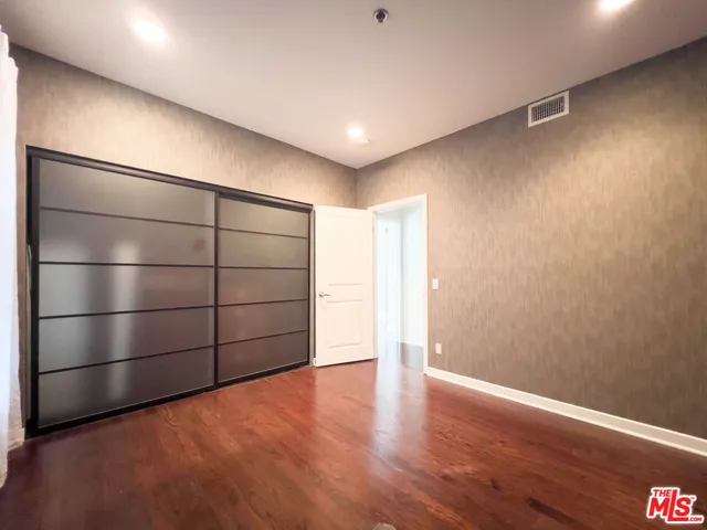 a bedroom with a bed and a potted plant