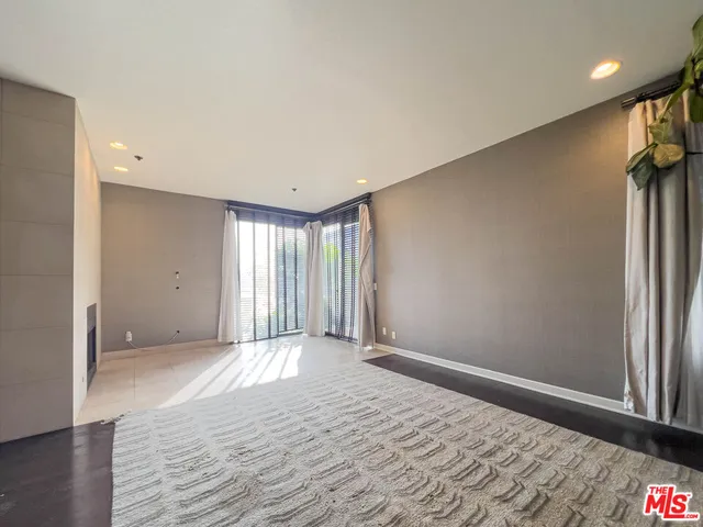 a view of an empty room and a window