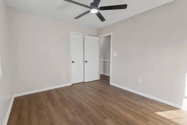 a view of an empty room with wooden floor