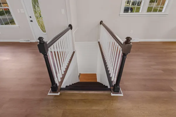 a view of staircase with wooden floor and windows