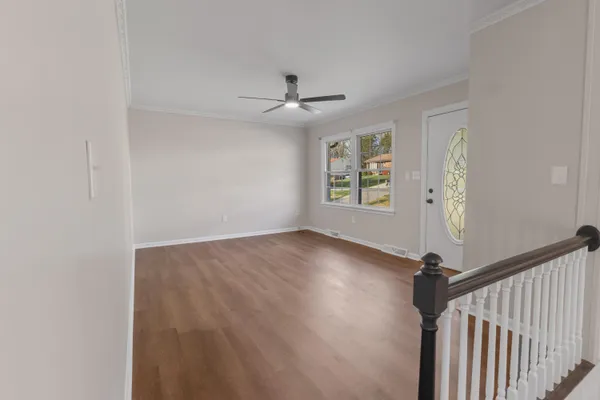wooden floor in an empty room with a window