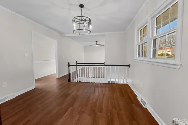 a view of entryway and hall with wooden floor