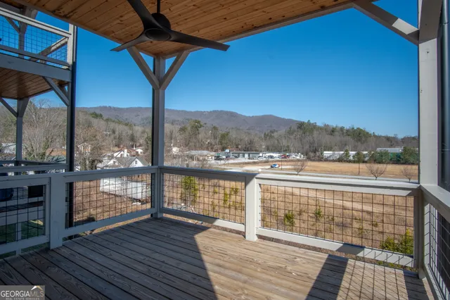 a view of a balcony with wooden floor and outdoor space