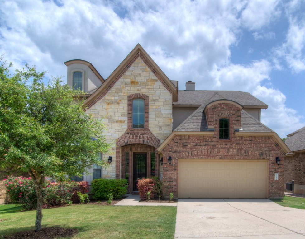 4529 Pyrenees Pass Bee Cave, TX 78738 - Photo 1 of 1 a front view of a house with garden