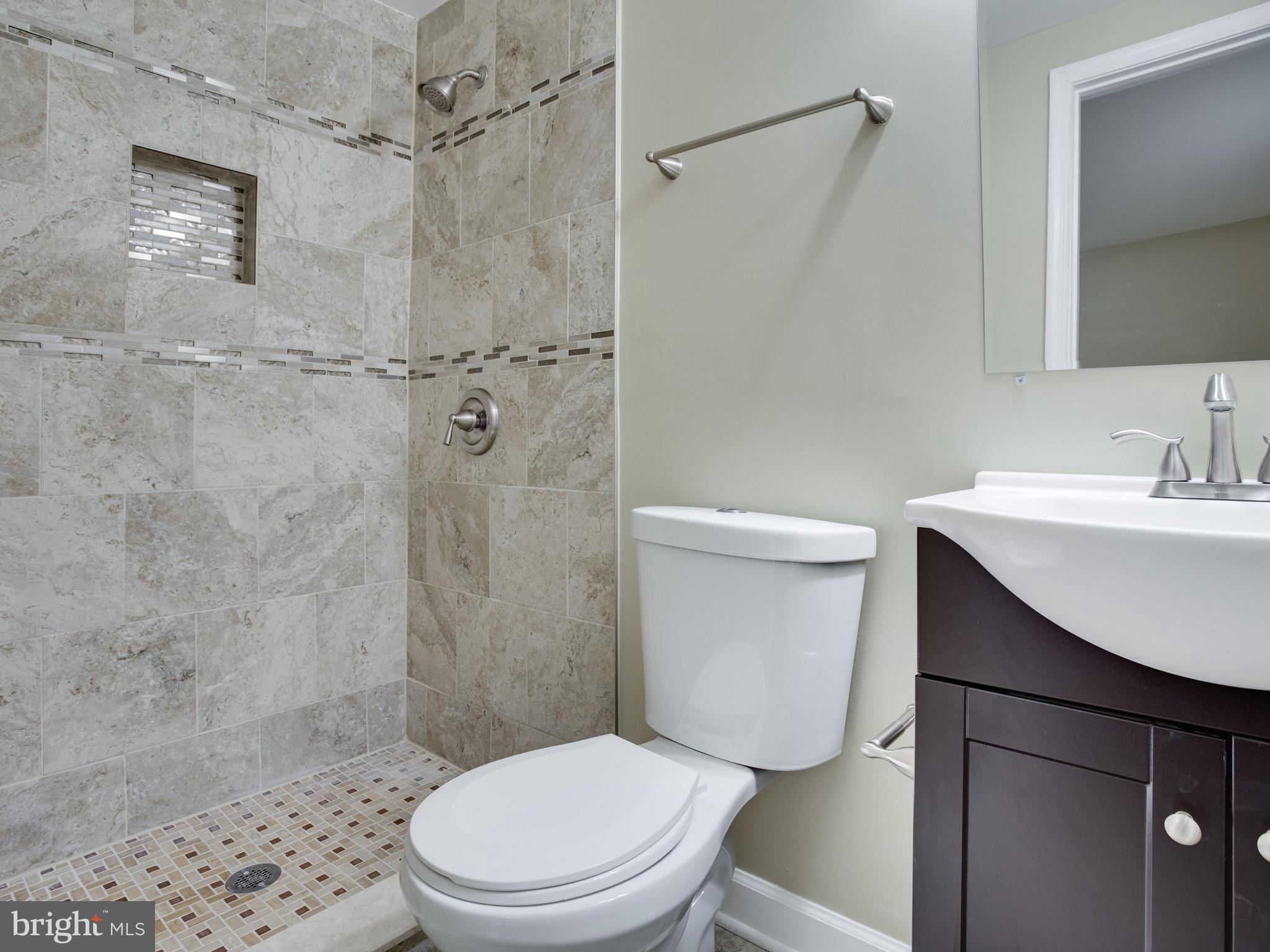 3411 Oaklawn Road Fort Washington, MD 20744 - Photo 11 of 30 a white toilet sitting next to a bathroom sink