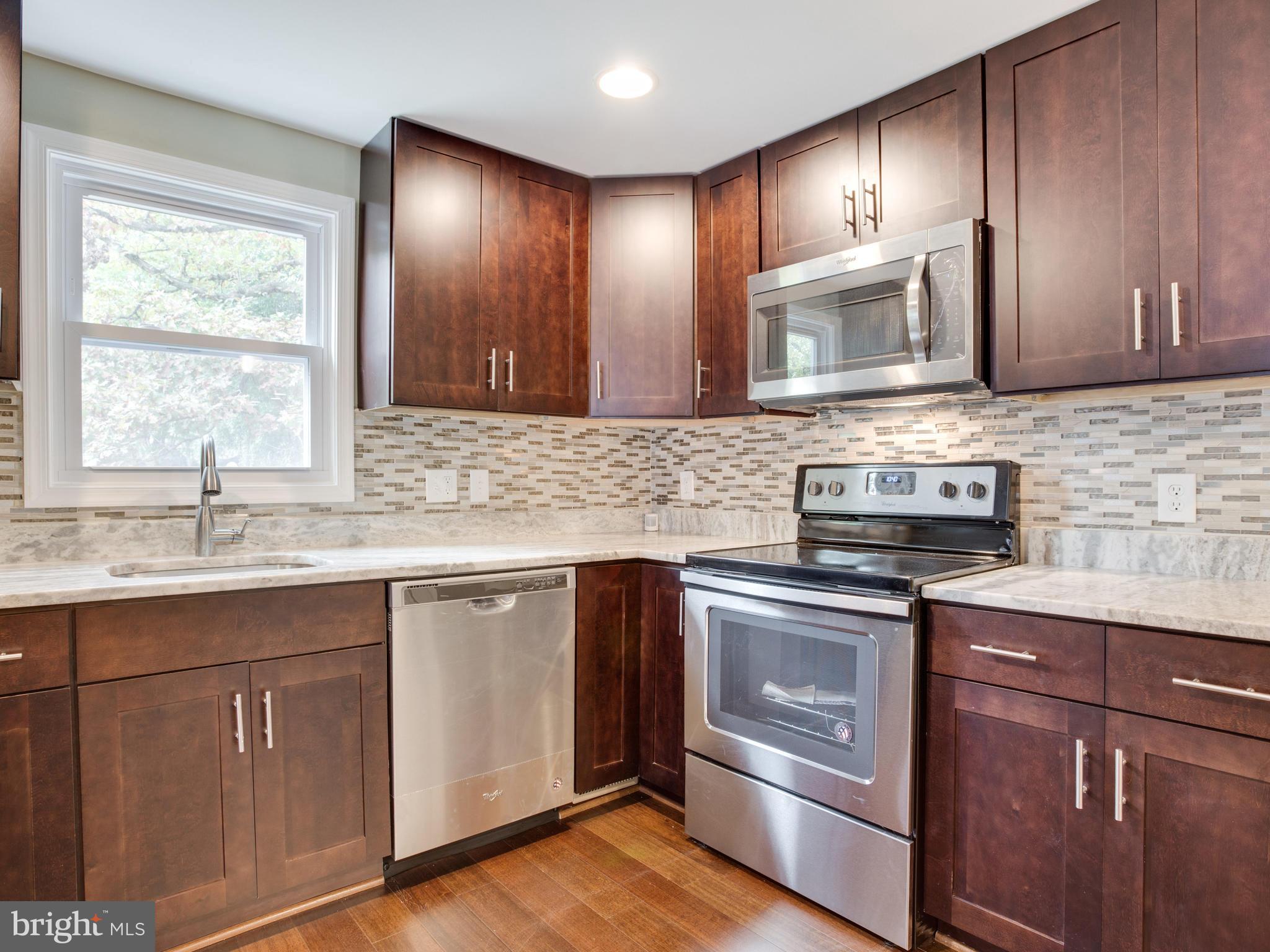 3411 Oaklawn Road Fort Washington, MD 20744 - Photo 3 of 30 a kitchen with stainless steel appliances granite countertop a sink stove and microwave
