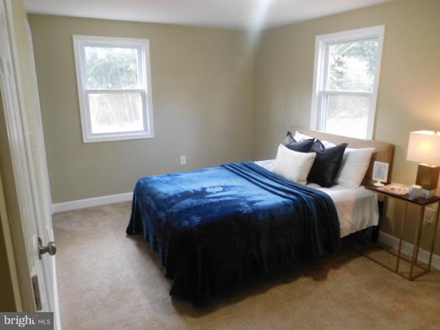 3411 Oaklawn Road Fort Washington, MD 20744 - Photo 21 of 30 a bedroom with a bed lamp and a window