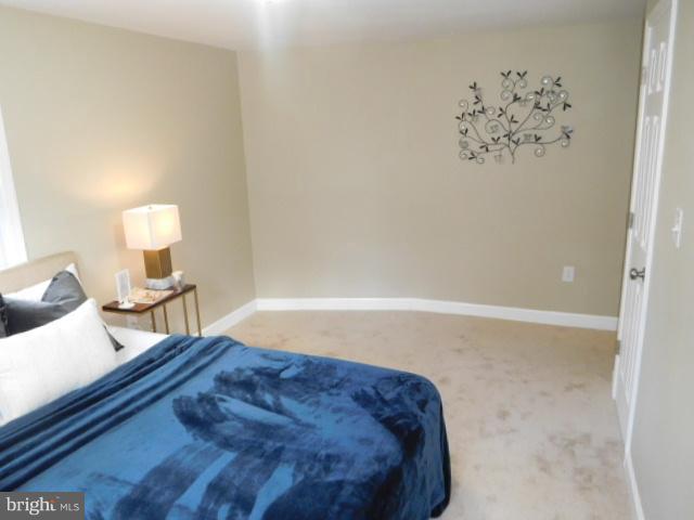 3411 Oaklawn Road Fort Washington, MD 20744 - Photo 22 of 30 a bedroom with a bed and a lamp with the wooden floor