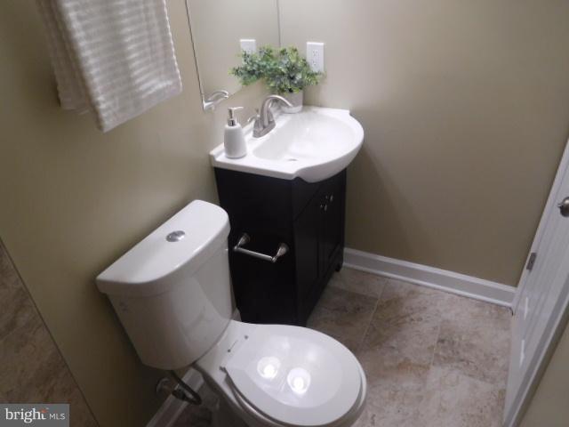 3411 Oaklawn Road Fort Washington, MD 20744 - Photo 30 of 30 a bathroom with a toilet sink and mirror
