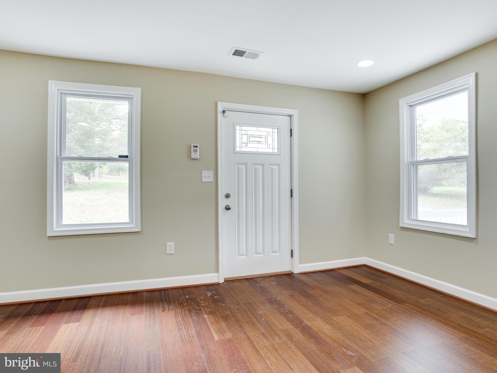 3411 Oaklawn Road Fort Washington, MD 20744 - Photo 6 of 30 an empty room with wooden floor and windows