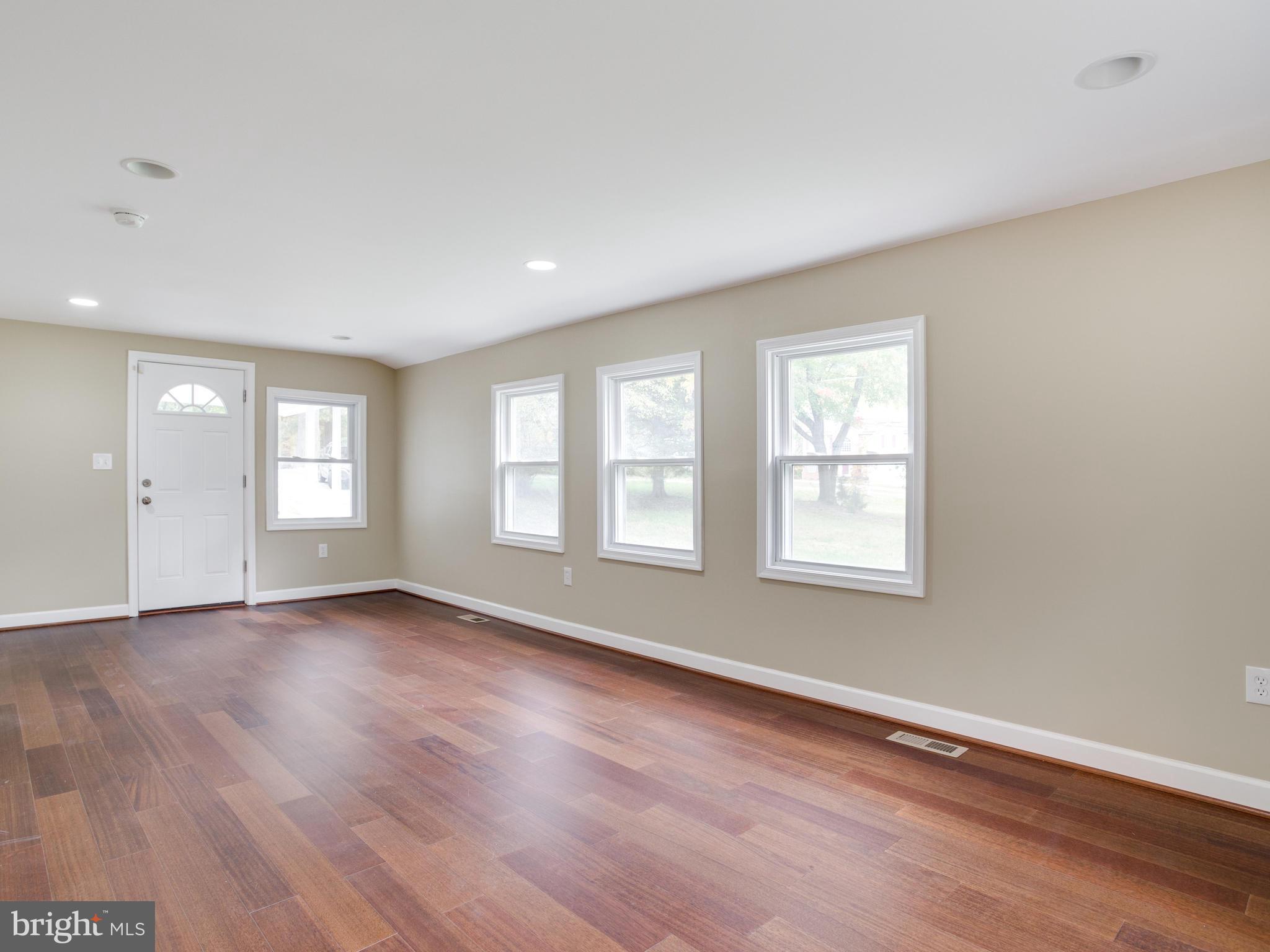 3411 Oaklawn Road Fort Washington, MD 20744 - Photo 7 of 30 an empty room with wooden floor and windows