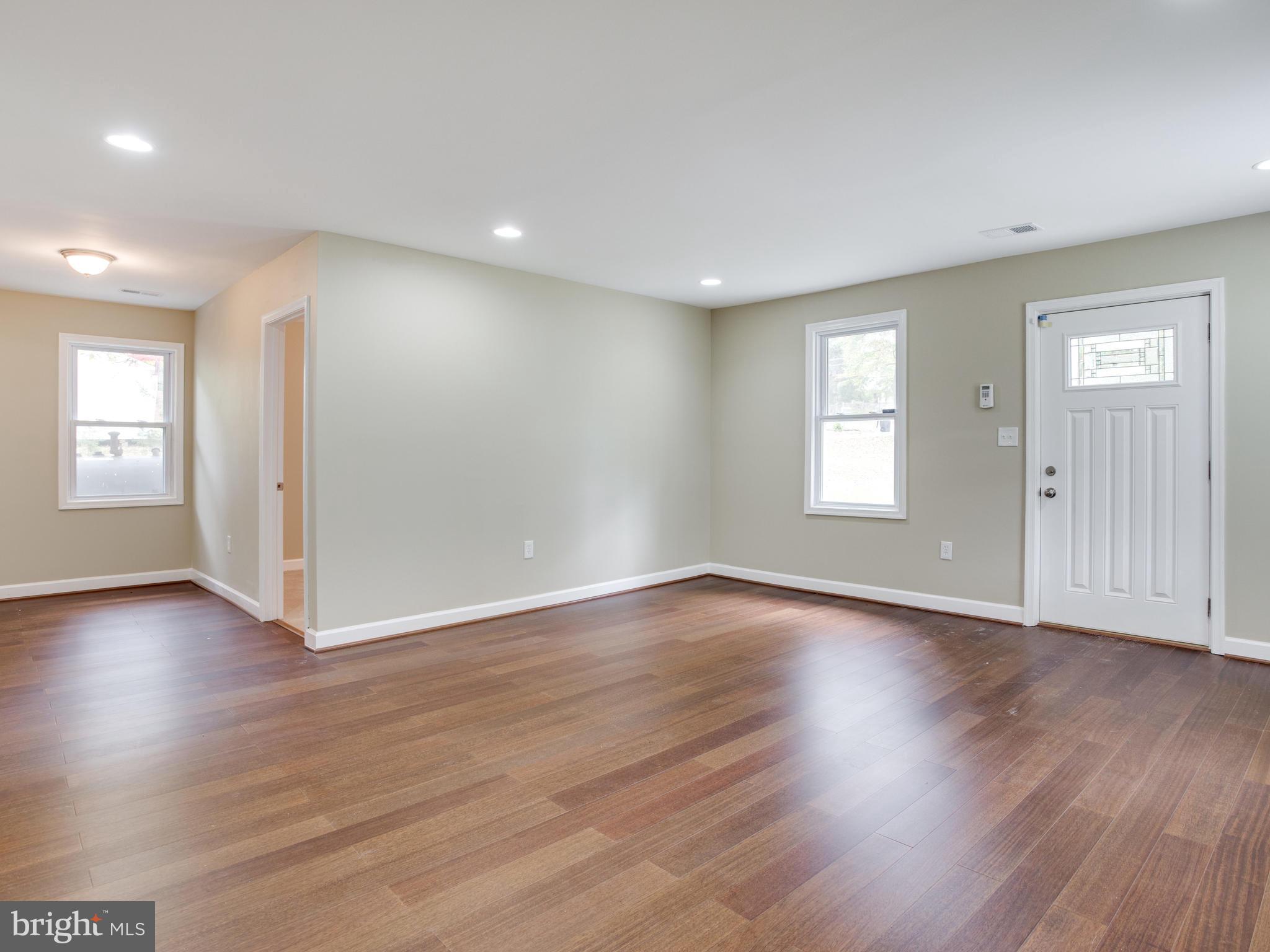 3411 Oaklawn Road Fort Washington, MD 20744 - Photo 9 of 30 a view of an empty room with wooden floor and windows