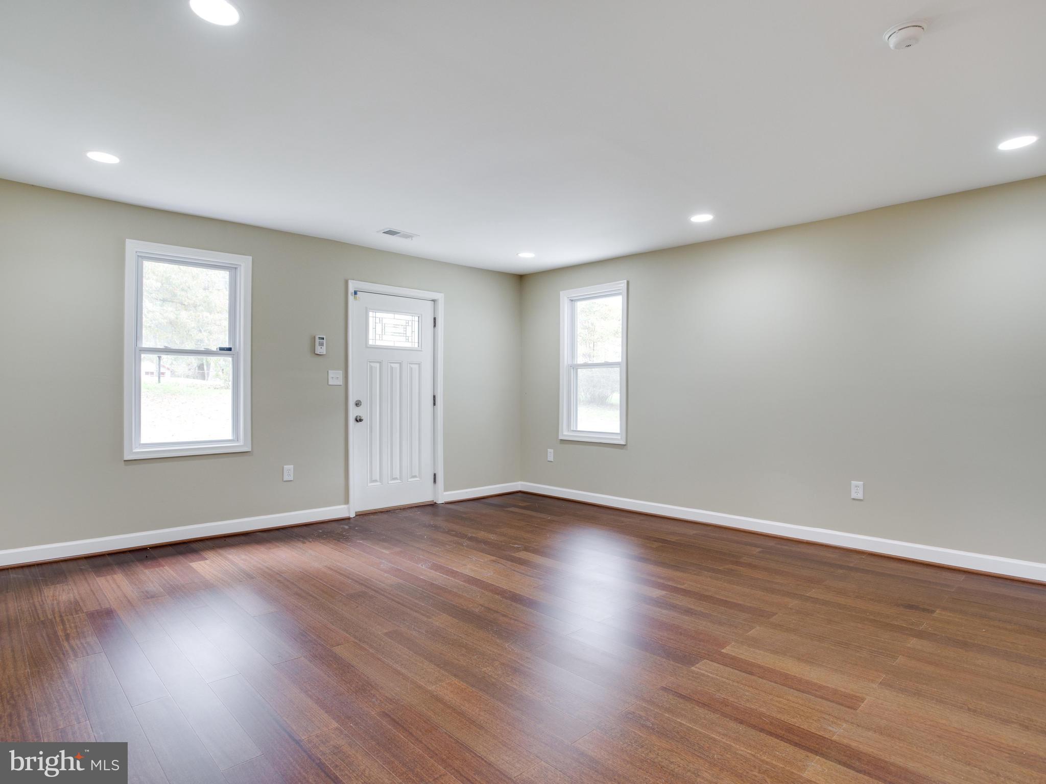 3411 Oaklawn Road Fort Washington, MD 20744 - Photo 10 of 30 an empty room with wooden floor and windows