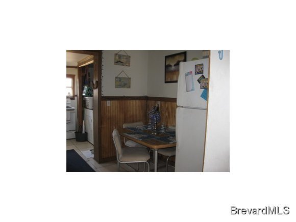 1119 Northeast Jordan Palm Bay, FL 32905 - Photo 5 of 12 a kitchen with a sink and refrigerator