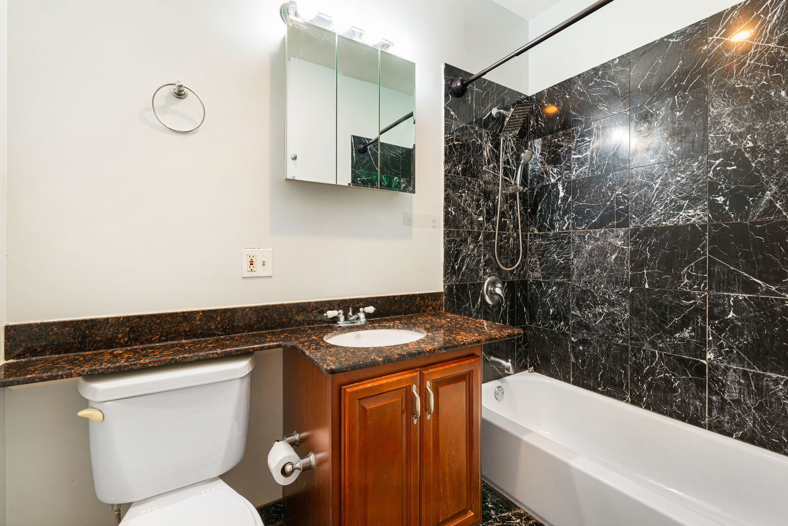 6324 South Kimbark Avenue, Unit 104 Chicago, IL 60637 - Photo 11 of 18 a bathroom with a granite countertop sink a toilet and shower
