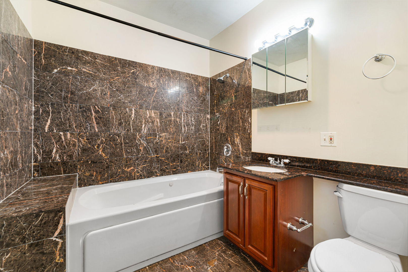 6324 South Kimbark Avenue, Unit 104 Chicago, IL 60637 - Photo 17 of 18 a bathroom with a granite countertop sink toilet and bathtub