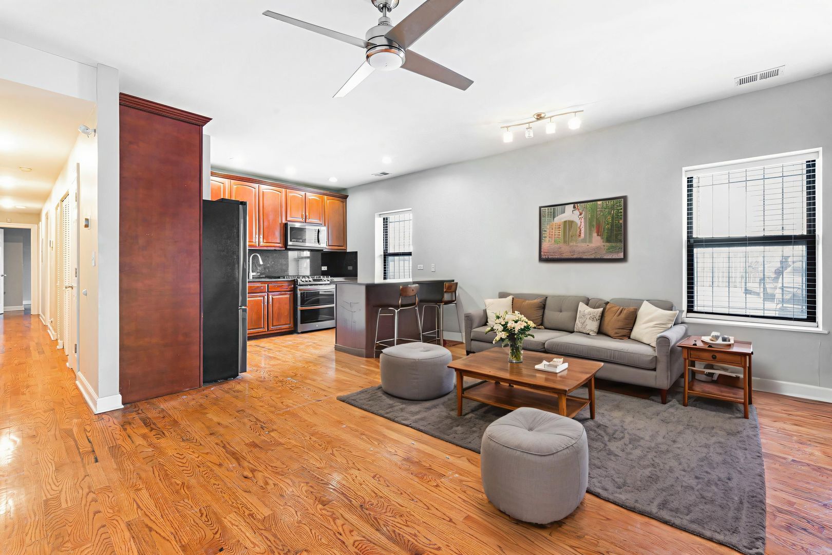 6324 South Kimbark Avenue, Unit 104 Chicago, IL 60637 - Photo 6 of 18 a living room with furniture a chandelier and a window