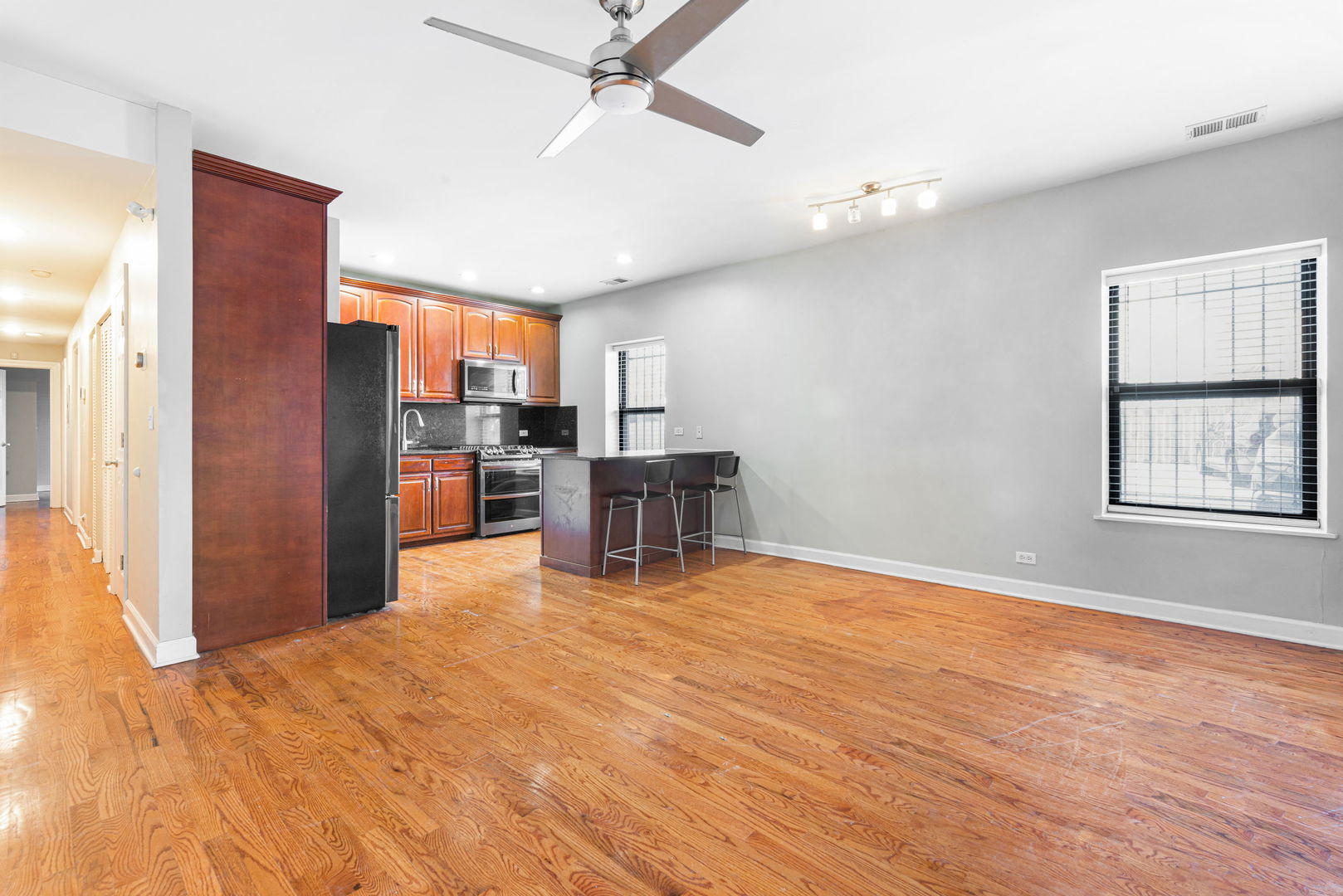 6324 South Kimbark Avenue, Unit 104 Chicago, IL 60637 - Photo 7 of 18 a kitchen with stainless steel appliances kitchen island granite countertop a refrigerator and a stove top oven