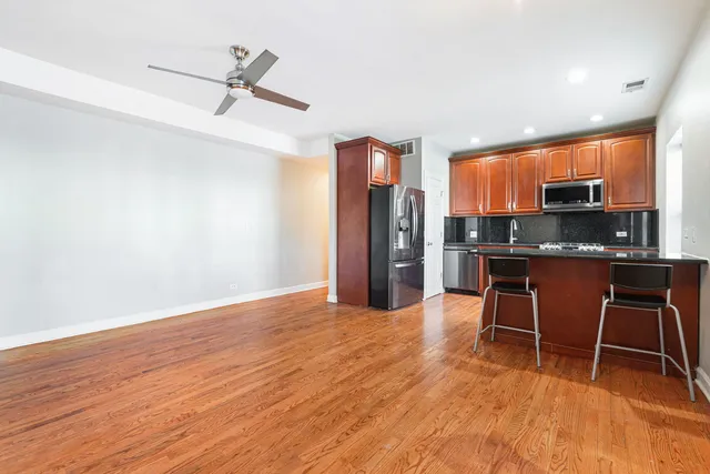 a kitchen with stainless steel appliances a refrigerator and microwave