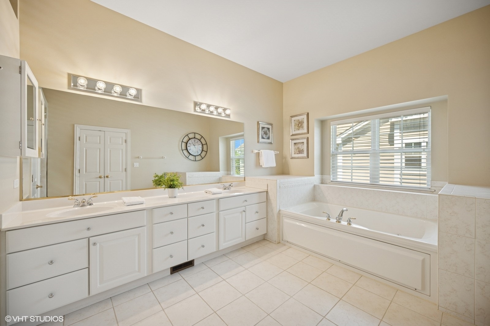1613 Constitution Drive Glenview, IL 60026 - Photo 20 of 40 a spacious bathroom with a granite countertop sink mirror and a bathtub