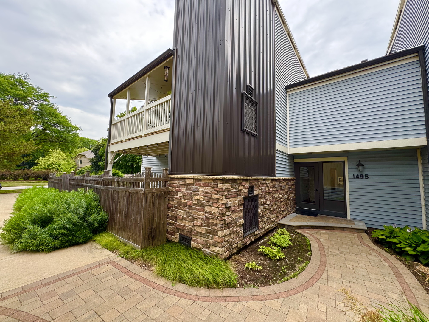 1495 South County Farm Road, Unit 24 Wheaton, IL 60189 - Photo 1 of 26 a front view of a house with garden