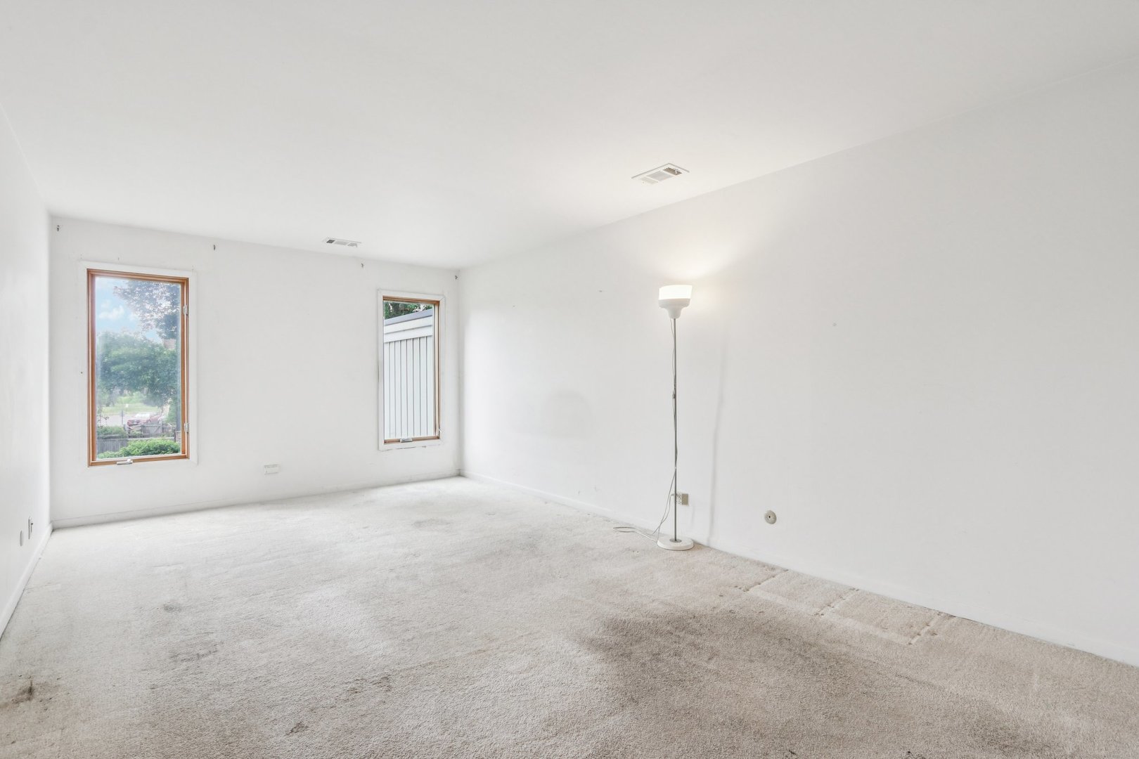 1495 South County Farm Road, Unit 24 Wheaton, IL 60189 - Photo 12 of 26 an empty room with windows and closet