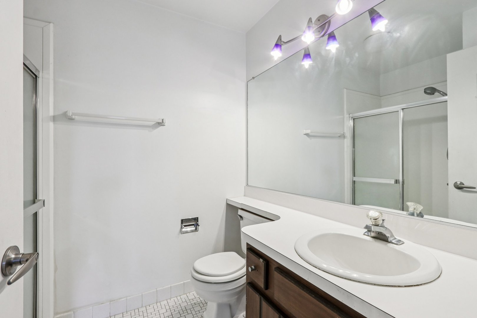 1495 South County Farm Road, Unit 24 Wheaton, IL 60189 - Photo 15 of 26 a bathroom with a sink and a mirror