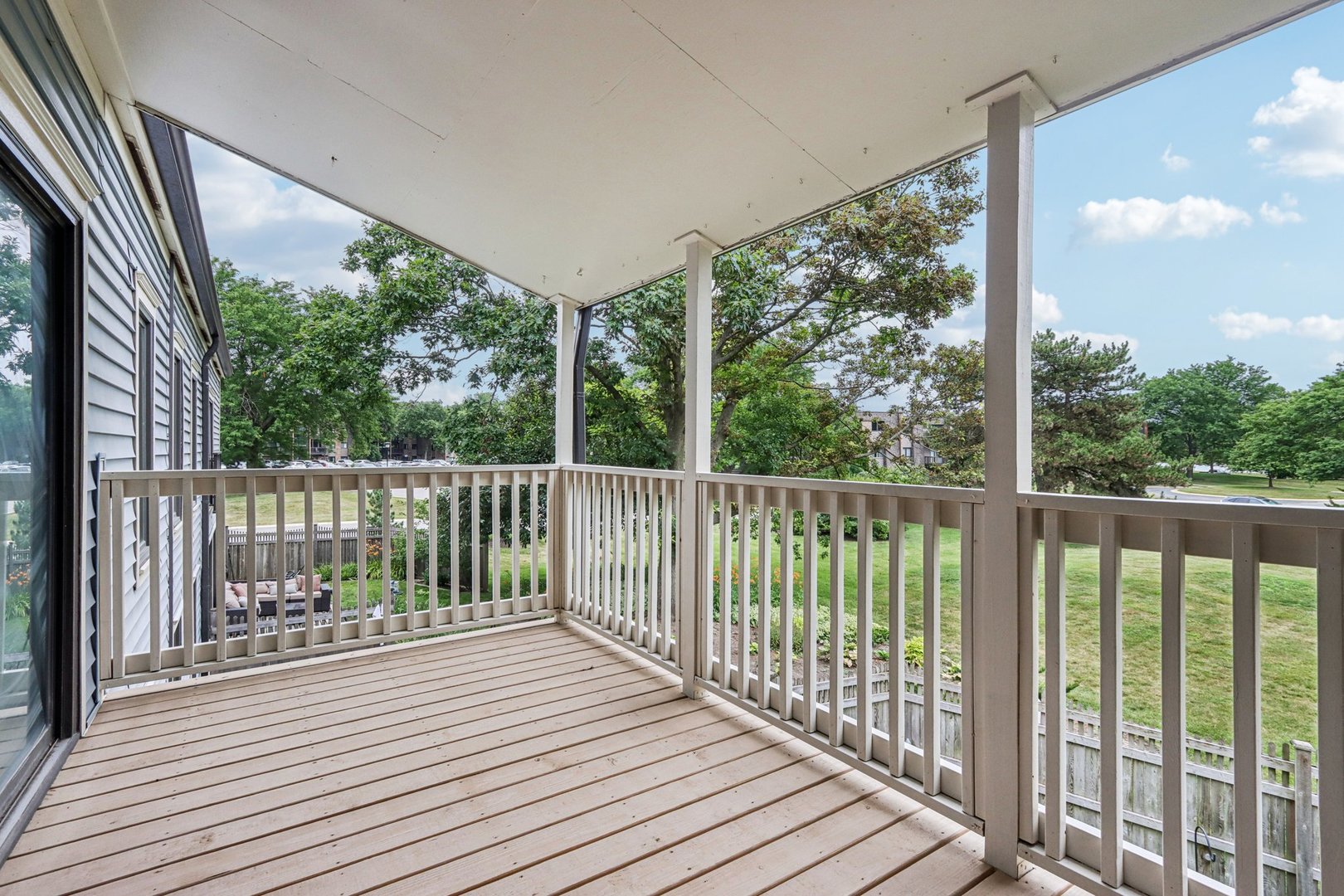 1495 South County Farm Road, Unit 24 Wheaton, IL 60189 - Photo 2 of 26 a view of a balcony with wooden floor